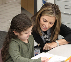 student working with teacher